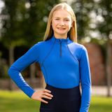 Girl wears a blue base layer in a garden setting