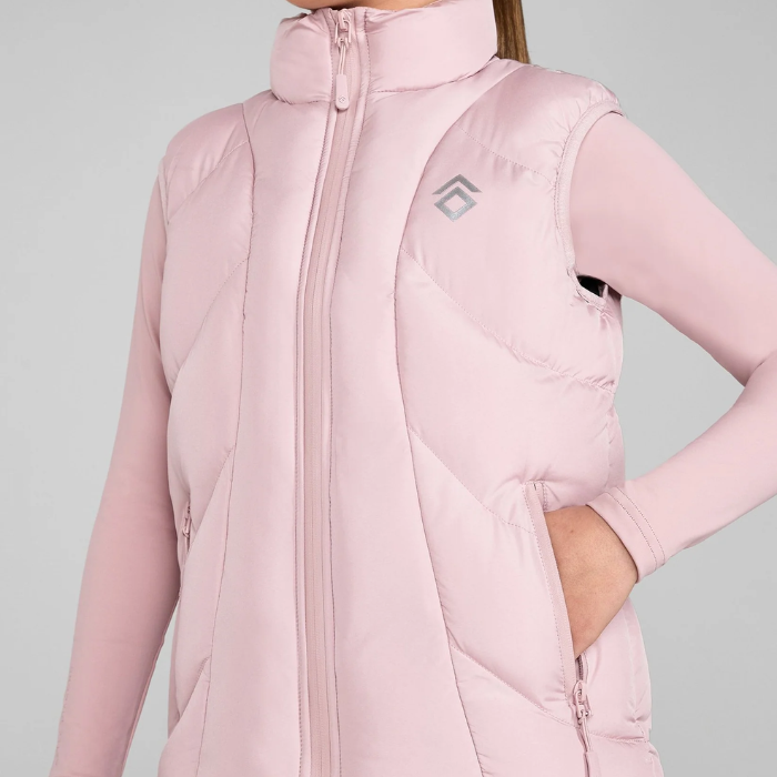 Pink puffer gilet worn by a person on a grey background