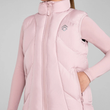 Pink puffer gilet worn by a person on a grey background