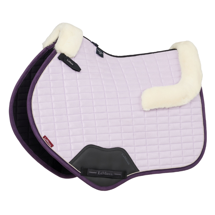 Lilac saddle pad for horses with merino wool elements on a white background