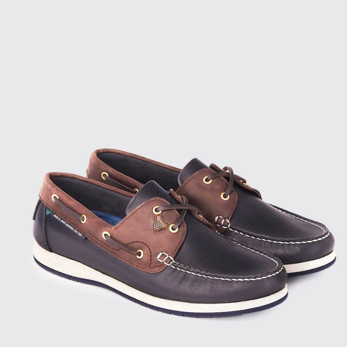 Pair of brown and navy boat shoes on a light grey background
