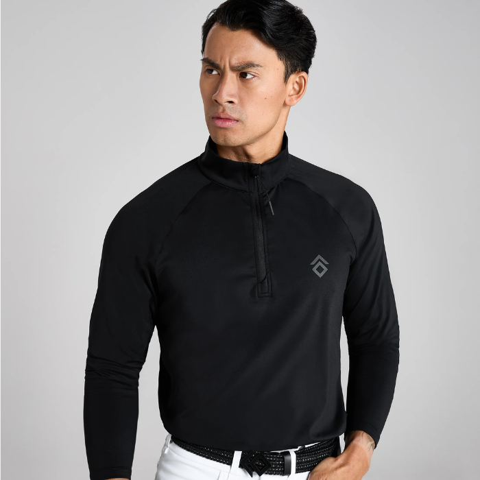 Man wearing a black long-sleeve shirt with a logo on a grey background