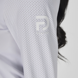 Close-up of a white sleeve with a logo, blurred background