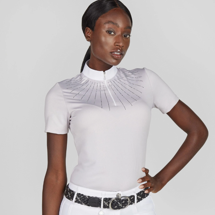 Woman wearing a white short-sleeve top with a decorative collar against a light grey background