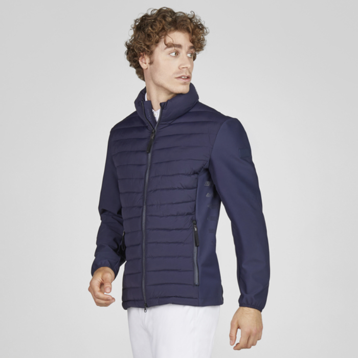 Man wearing a navy blue puffer jacket on a light grey background