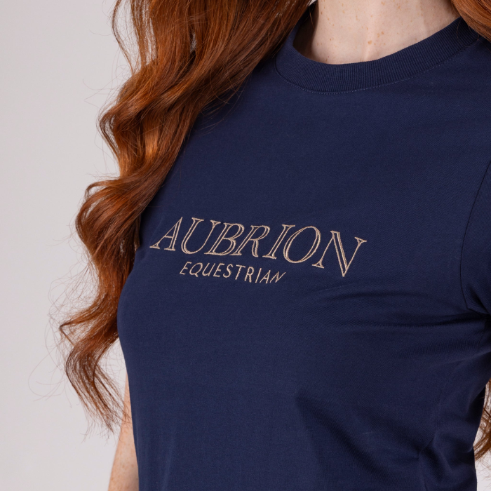 Navy blue sweatshirt with 'Aubrion Equestrian' logo worn by a person with red hair.