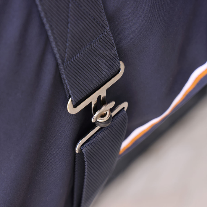 Close-up of a navy blue rug with a strap and metal buckle on a light gray background